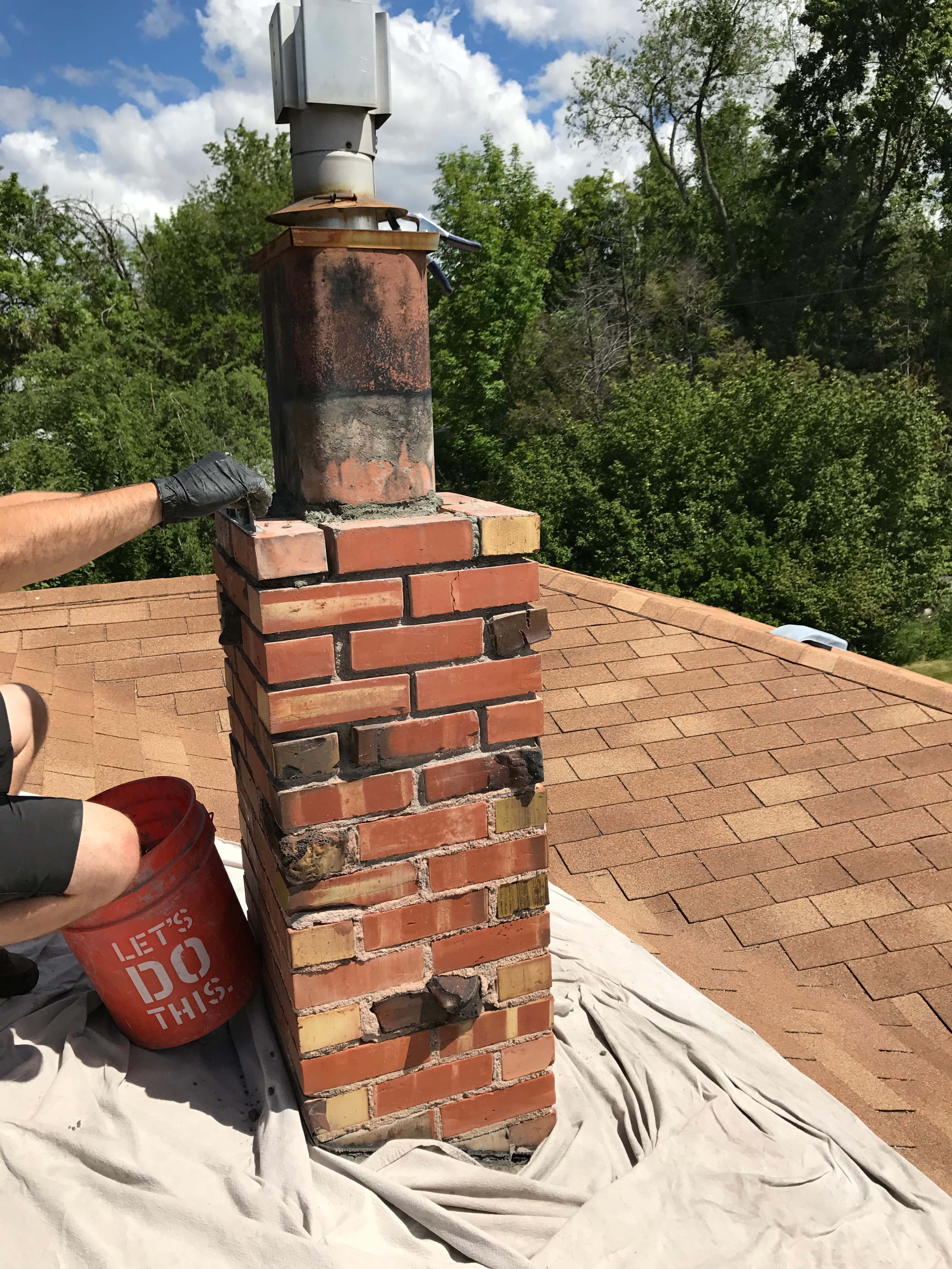 Technician doing chimney tuckpointing repair