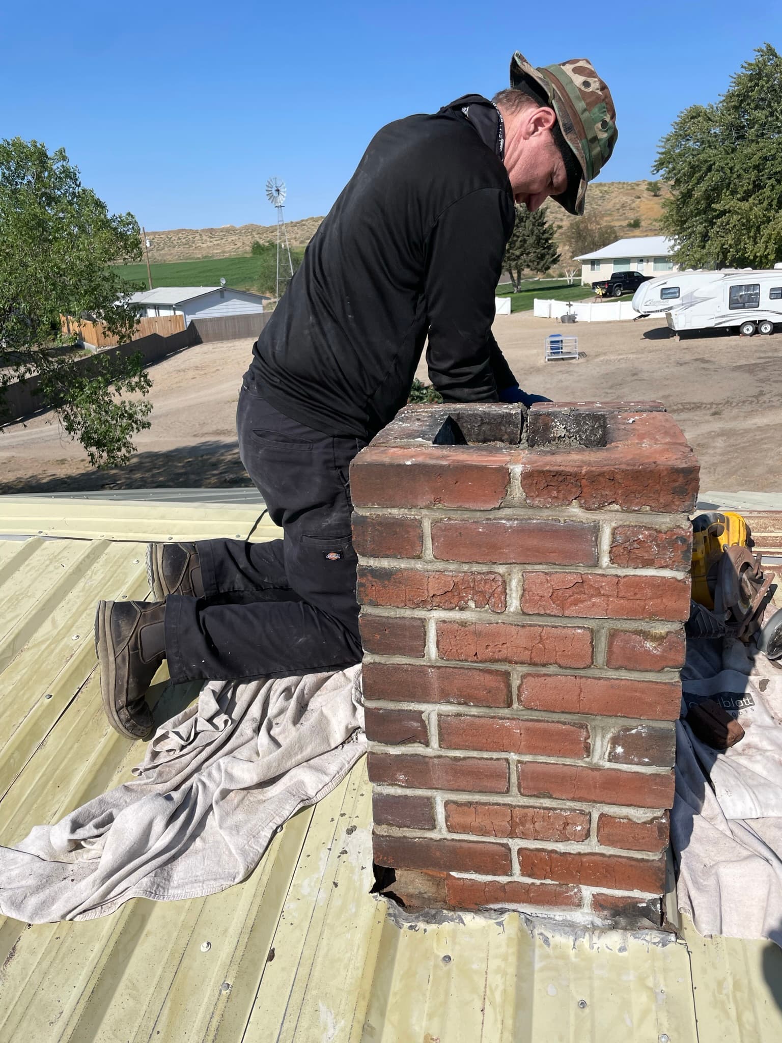 AFCS technician performing masonry chimney repair on a rural Idaho home