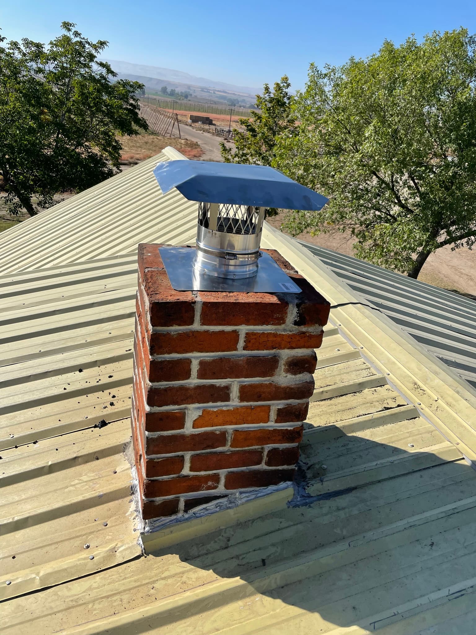 New stainless steel chimney cap installed on a Treasure Valley home